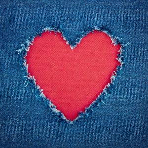 Blue denim background with red heart